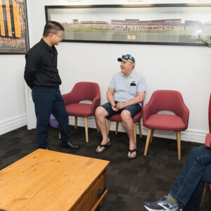 Dr Chris Oh with patient in reception area